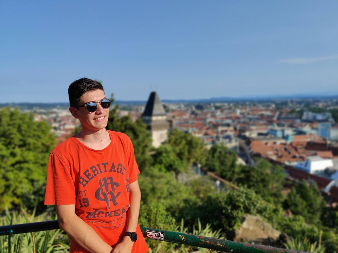 Felix Schneider looking into the distance with the Graz clock tower in the background